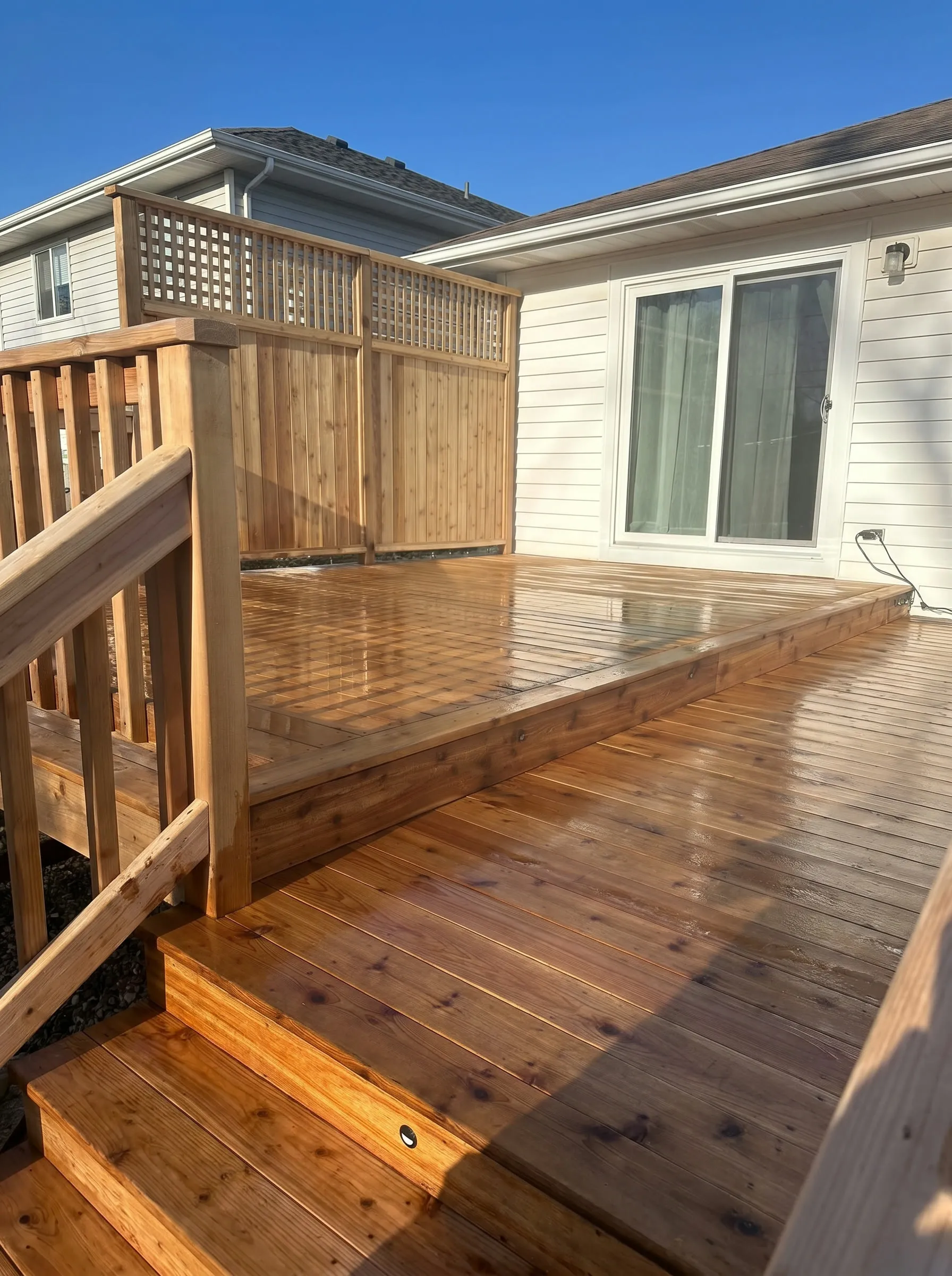 Natural cedar deck with matching steps and a cedar lattice privacy panel