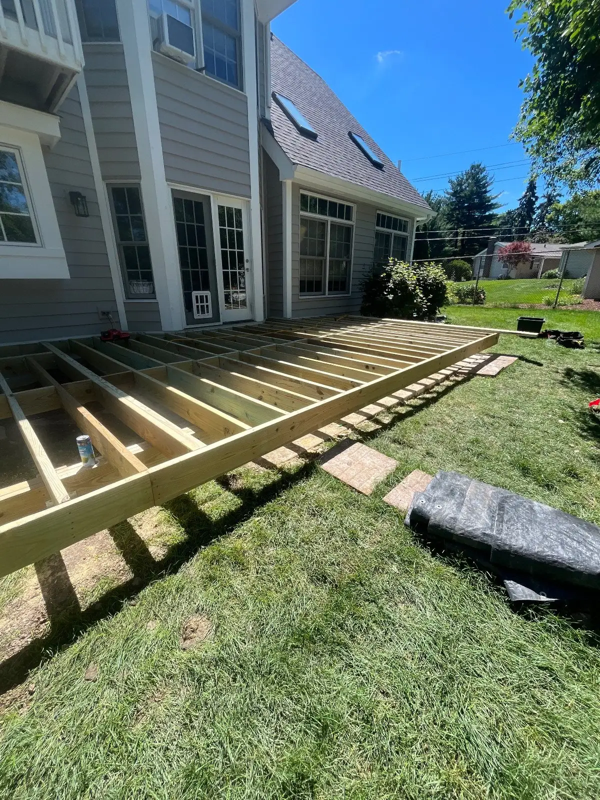 Pressure-treated joists running the length of the house before the Trex boards go on