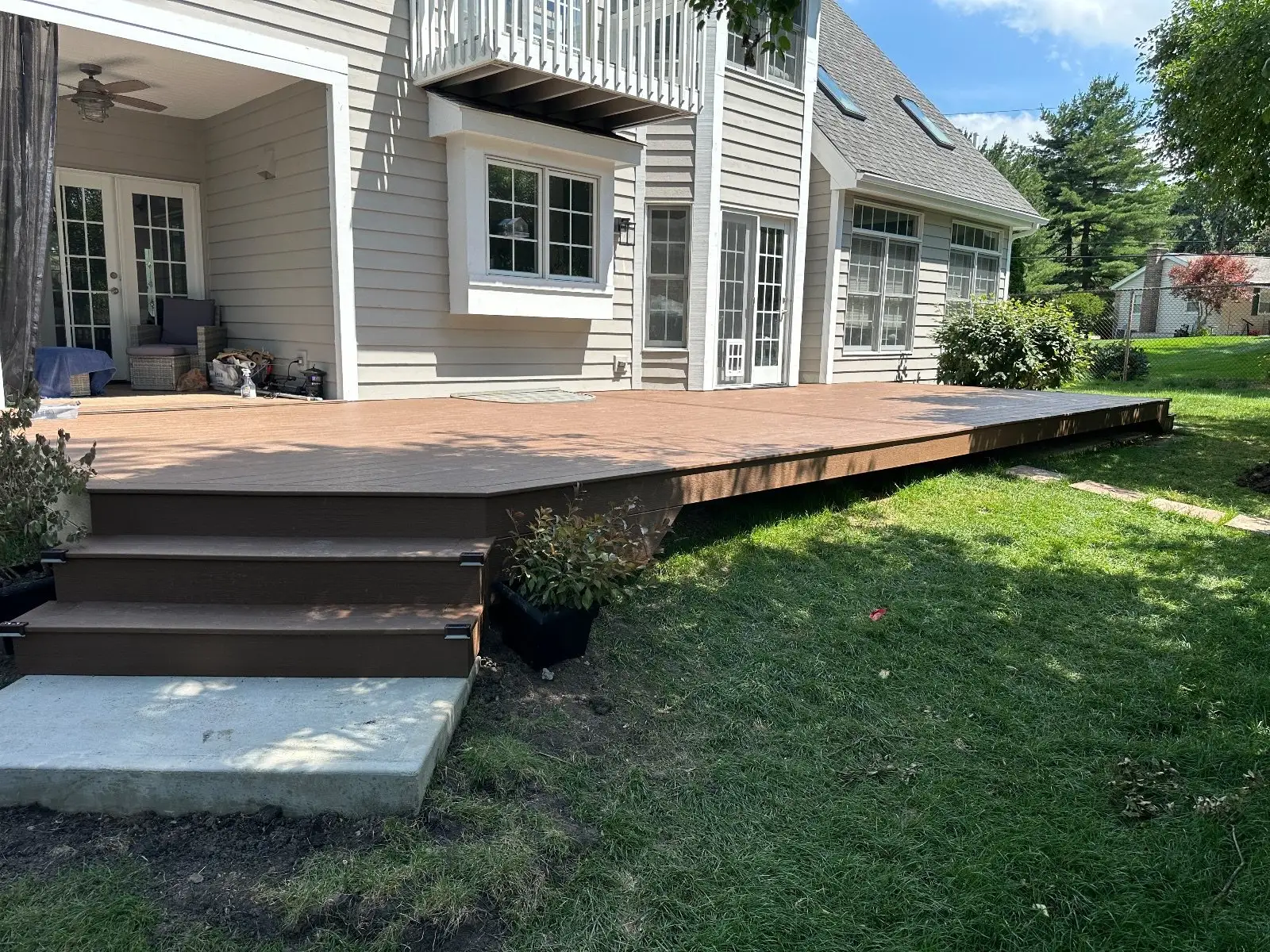 The whole 42 foot deck run from the yard with both step-downs and the balcony above