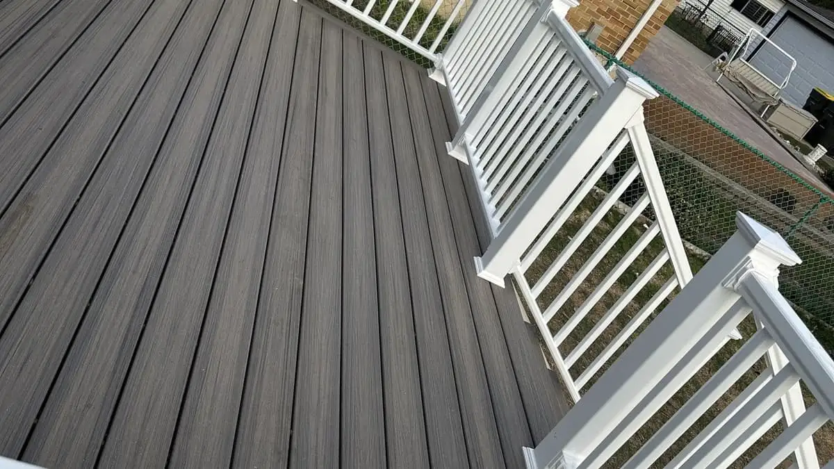 Grey composite deck with white railings on a Roselle home after the rebuild