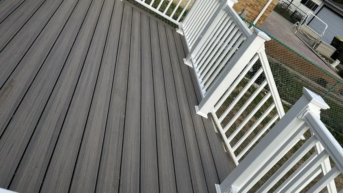 Grey composite deck with white railings on a Roselle home after the rebuild